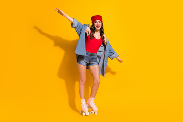 Full length photo positive youth street style girl hold hands imagine she fast speedy plane riding roller skates wear red headwear denim jeans singlet isolated bright color background