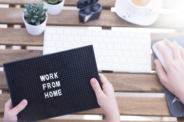 Naklejka premium Work from home concept due to quarantine with computer keyboard and coffee cup 
