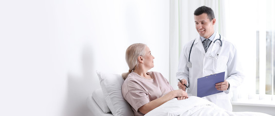 Doctor visiting his patient in hospital ward, space for text. Banner design
