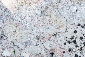 Obraz premium Old stone wall with cracks and dust, textured background