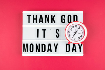 Lightbox on a red background, text Thank you God it's Monday day and alarm clock