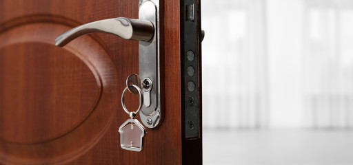 Closeup view of door with key open into empty room