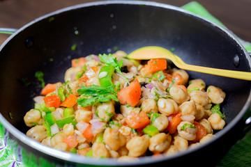 fresh chic pea salad with tomato, onion, capcicum, black raisins and coriander leaves