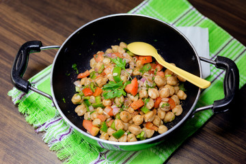 fresh chic pea salad with tomato, onion, capcicum, black raisins and coriander leaves