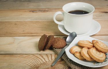 Coffee cup and cookie on wood
