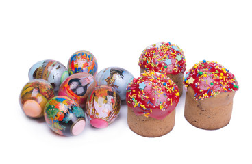 three Easter cakes covered with red icing, and several Easter eggs