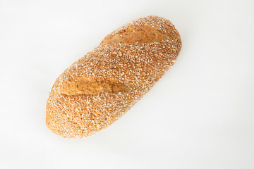 Homemade wheat bread with cereal grains. Fresh loaf isolated on white background. Studio shot. Top view. Cooking and baking at home concept