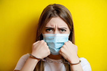 woman wearing mask showing handcuffs