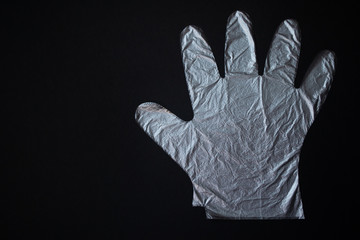 Disposable plastic gloves on a black background. Protection concept. Stop coronavirus.