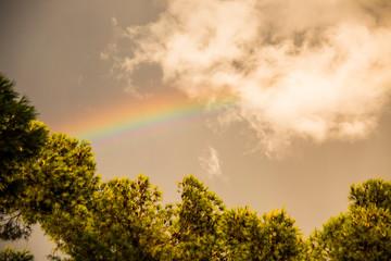 Sunset and rainbow in Platja Llarga beach, Tarragona, Spain