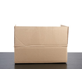 open cardboard box stands on a black table, white isolated background