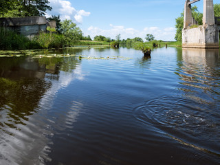 Fototapeta premium Abandoned old canal and destroyed bridge. Artificial pond canal.