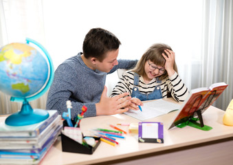 Two children at home doing homework. Home education, distance learning during CoVid-19 quarantine