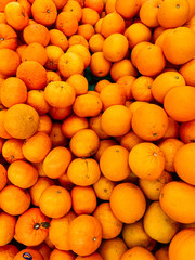 lots of ripe citrus yellow tangerines for eating like a background