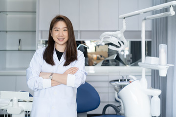Portrait of female dentist .She standing in her dentist office.