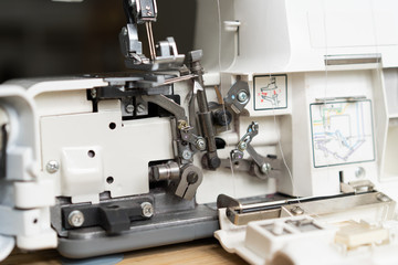 repair of sewing equipment, overlock. hand and a screwdriver fixes the breakage sewing machine