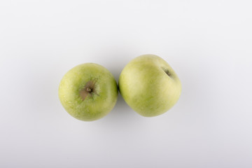 Ripe green apple on a white background