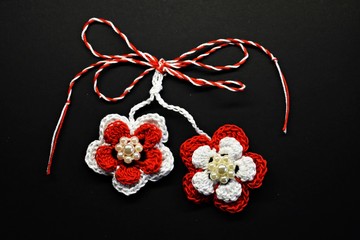 Handmade crocheted flower with red and white string, known as Martisor, it is a Romanian...