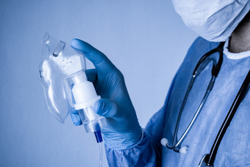 Doctor holding oxygen mask in his hand. Conceptual photograph for Covid-19 and Coronavirus outbreak.