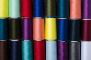 Top view of colorful spool of thread as a background.Rows of bobbins