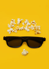 Abstract image of viewer, 3D glasses and popcorn on yellow background. Concept cinema and entertainment.