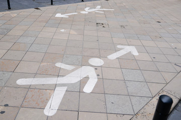 Naklejka premium traffic arrow direction sign for pedestrians in the pedestrian street in Bordeaux city France Concept of social distancing