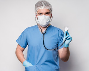 Portrait of male nurse holding medical stethoscope