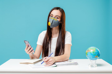woman learning with planet earth globe and phone with books wearing mask on blue background