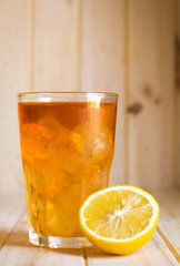 Glasses of ice tea with lemon slices  on wooden background