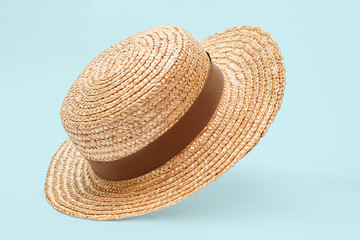 Boater straw hat flying isolated in studio. Concept of fashion clothing accessories and beach...