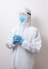 Fototapeta premium Pray for god blessing. Male doctor in protective suit.
