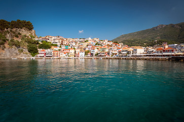 Fototapeta na wymiar the city of Parga, by the mediterranean sea, with it's houses and boats in the pier