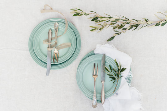 teal mint plate setting with olive branch on linen