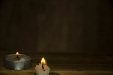Obraz na płótnie Canvas White candles on wooden table