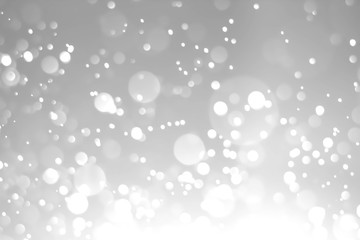 White glitter vintage lights background. White bokeh on black background.