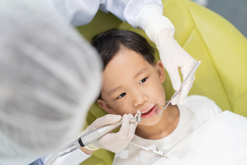 A boy having teeth examined at dentists: Healthy lifestyle, healthcare, and medicine concept.