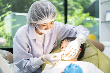 Obraz na płótnie Canvas A boy having teeth examined at dentists: Healthy lifestyle, healthcare, and medicine concept.