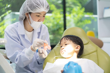 Obraz na płótnie Canvas A boy having teeth examined at dentists: Healthy lifestyle, healthcare, and medicine concept.
