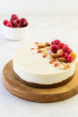 Raw almond cake on a wooden board. Healthy food concept. Lactose free, gluten free, sugar free.