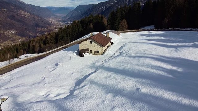 Isolated mountain barn in the snow