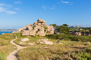 Perros-Guirec, France. Hiking trail among pink granite rocks