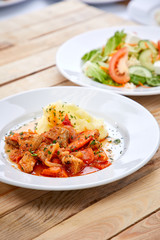 chicken with mashed potatoes and salad on the wooden background