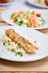 chicken kebab with rice and salad on the wooden background
