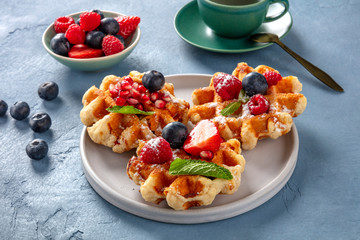 Belgian waffles with fresh fruit and mint leaves, a delicious breakfast