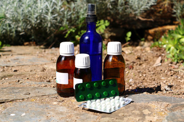 Different medecine bottles and pills. Homeopathic treatment. Blue bottle