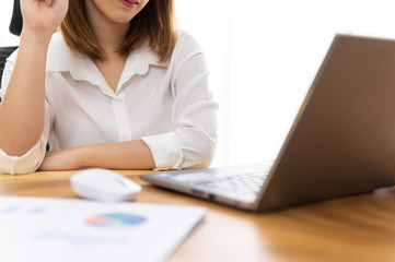 Fototapeta premium Young woman sale person analzing sale report on desk working at home