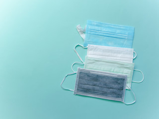 Surgical or medical face mask flat lay on blue background, Health care protection and surgical concept.