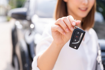 Car loan, contract agreement,buying and rent car concept, Saleperson holding car key on hand