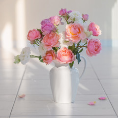 beautiful roses in ceramic white jug