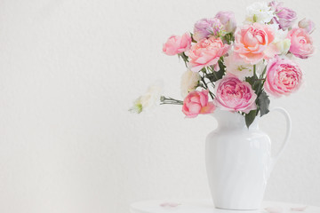 beautiful roses in ceramic white jug